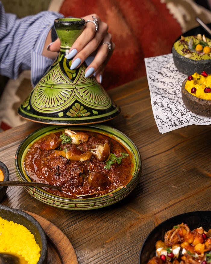 Vibrant Moroccan meal with tagine, couscous, and colorful sides, highlighting cultural richness.